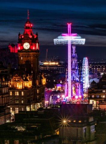The Balmoral hotel and Scott monument surrounded by the Christmas 'Rides'